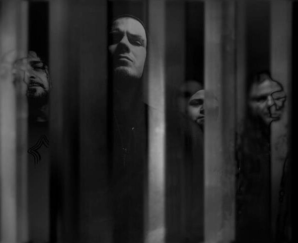 A black and white photo of a group of men behind bars.