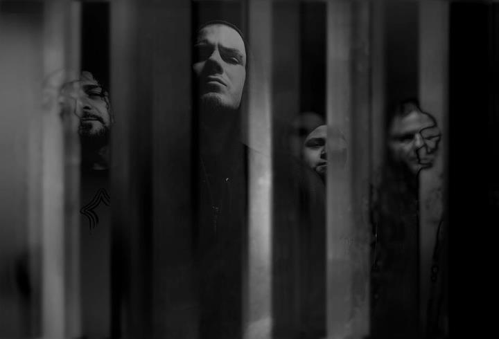 A black and white photo of a group of men behind bars.