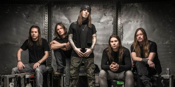 A group of men with long hair posing for a picture.