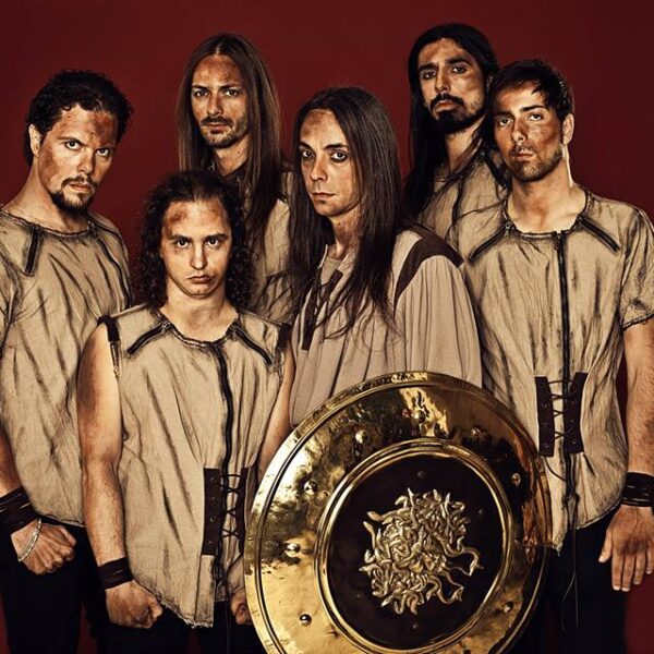 A group of men posing with a golden shield.