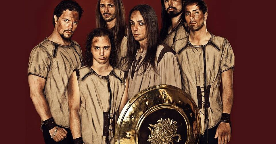 A group of men posing with a golden shield.