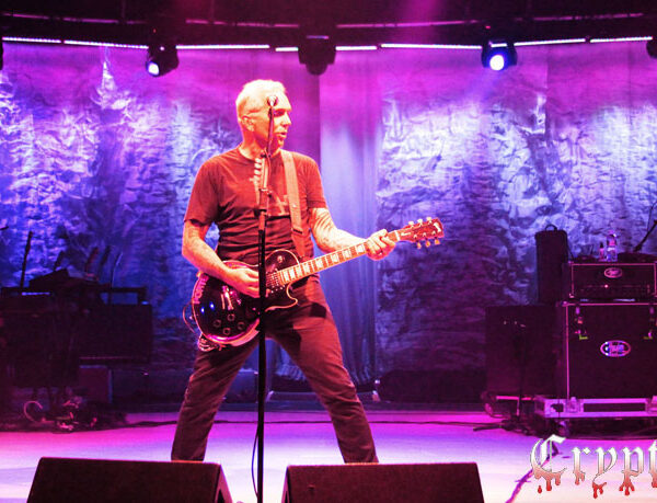 A group of people on stage with guitars.