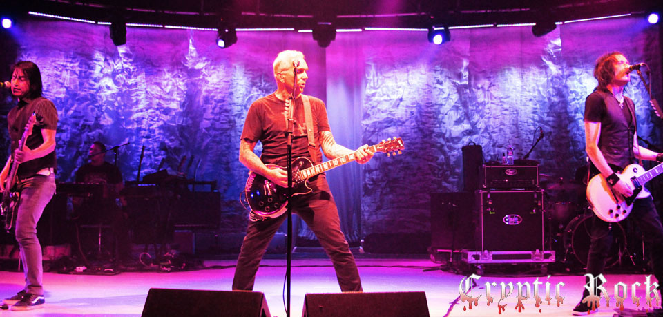 A group of people on stage with guitars.