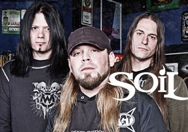 A group of men standing in front of a bar with the words soil.