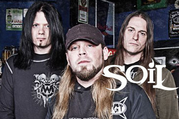 A group of men standing in front of a bar with the words soil.