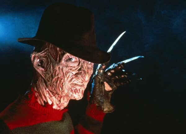 Freddy krueger is holding a knife in his hand.