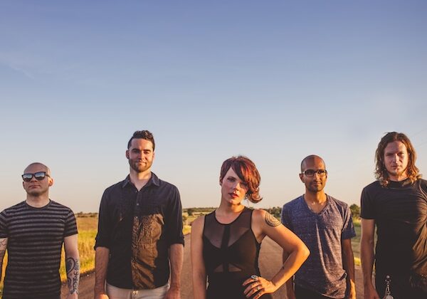 A group of people standing on a dirt road.