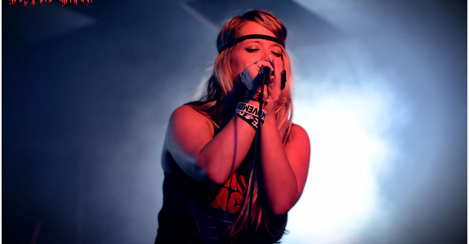 A woman singing into a microphone.