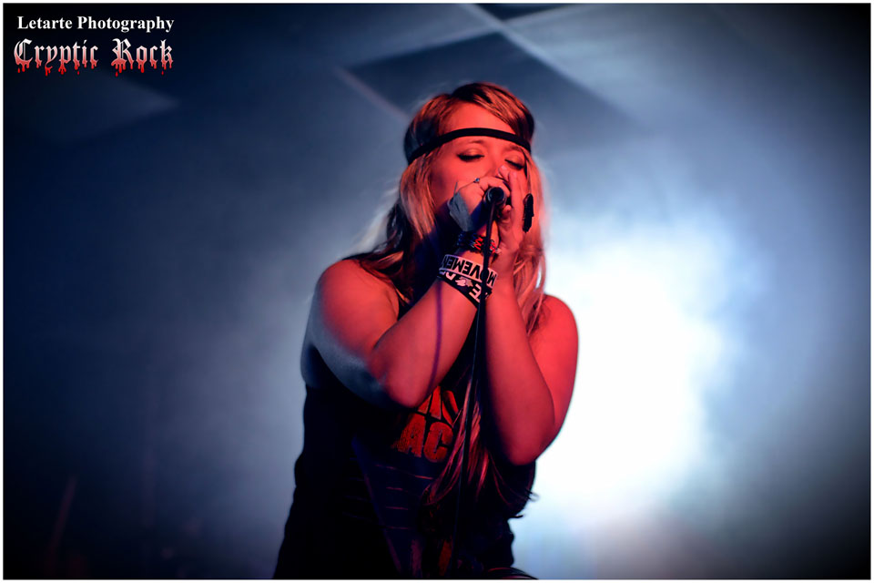 A woman singing into a microphone.