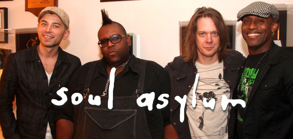 A group of men posing for a picture with the words soul asylum.