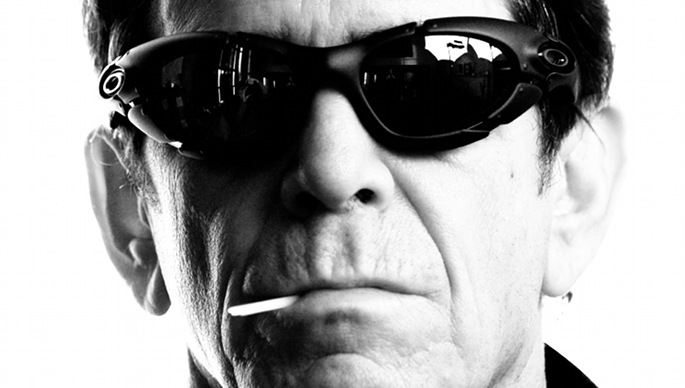 A man in sunglasses smoking a cigarette.