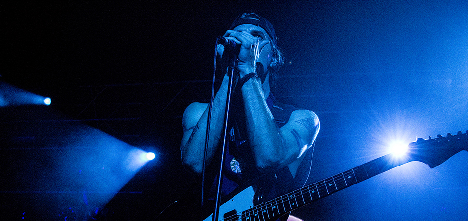 A man holding a guitar.