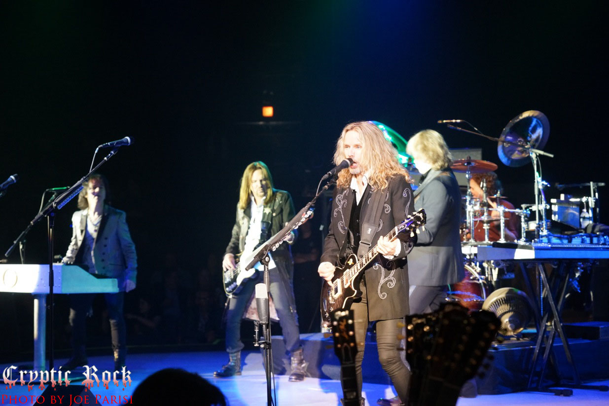 A group of people on stage at a concert.