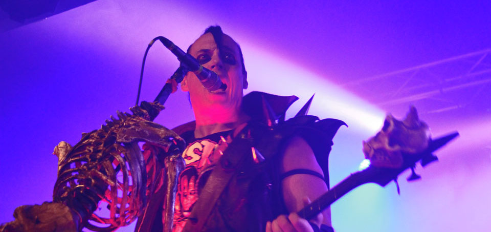 A man in a costume singing into a microphone.