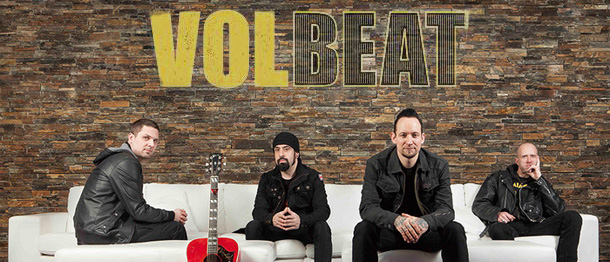 A poster for volbeat with a group of men sitting on a couch.