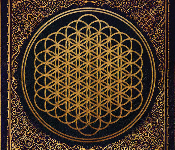 A black and gold cover of the flower of life.