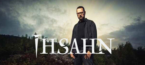 A man standing in front of a forest with the word thasan.